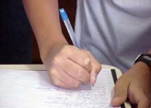 A child writing - schools not identifying children with Dyslexia